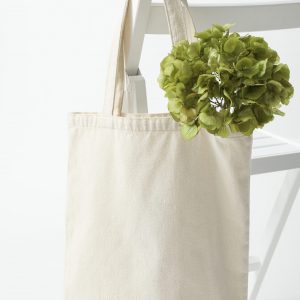 A white bag hangs on a white chair